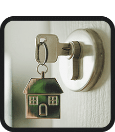 A key with a house on it hanging on a door, symbolizing inclusive employment for those looking for work or looking to hire.