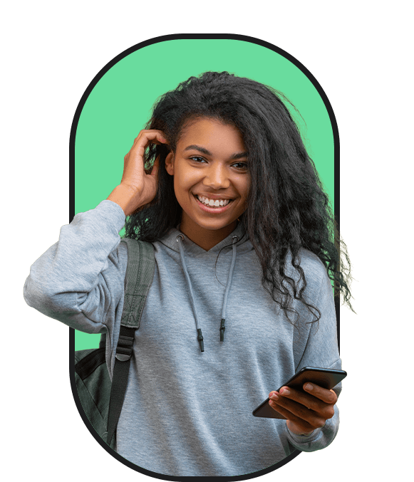A young woman with curly hair looking for work and listening to her cell phone.